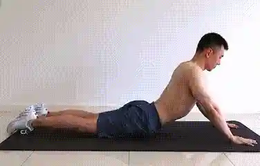 Man doing abdominal stretch on floor — cooldown after ab workout