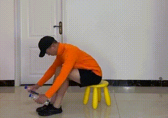 Seated person rowing with water bottles - mid-back calisthenics move