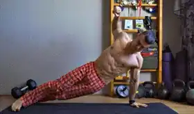 Person performing plank T-rotation for shoulder exercises using bodyweight.
