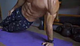 Man performing side shoulder push for shoulder exercises no equipment.