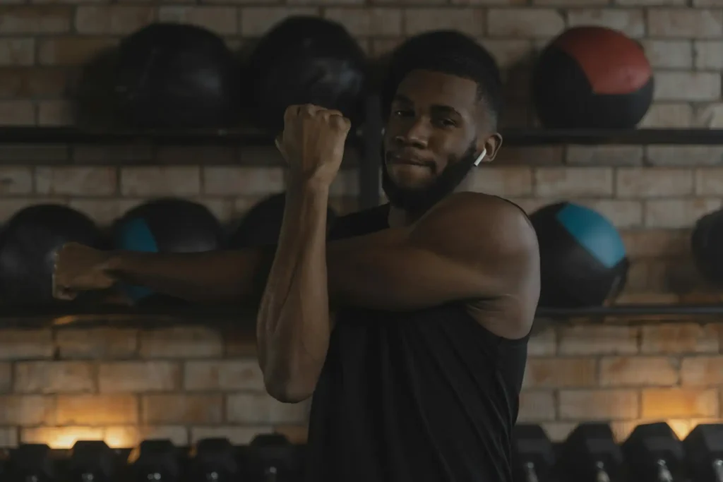 Man stretching his shoulder before a bodyweight shoulder Exercises.