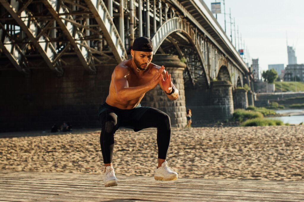 Man doing single leg jump on beach - calisthenics leg workout
