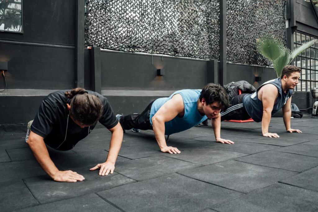 Two men doing push-ups outdoors - calisthenics workout no equipment