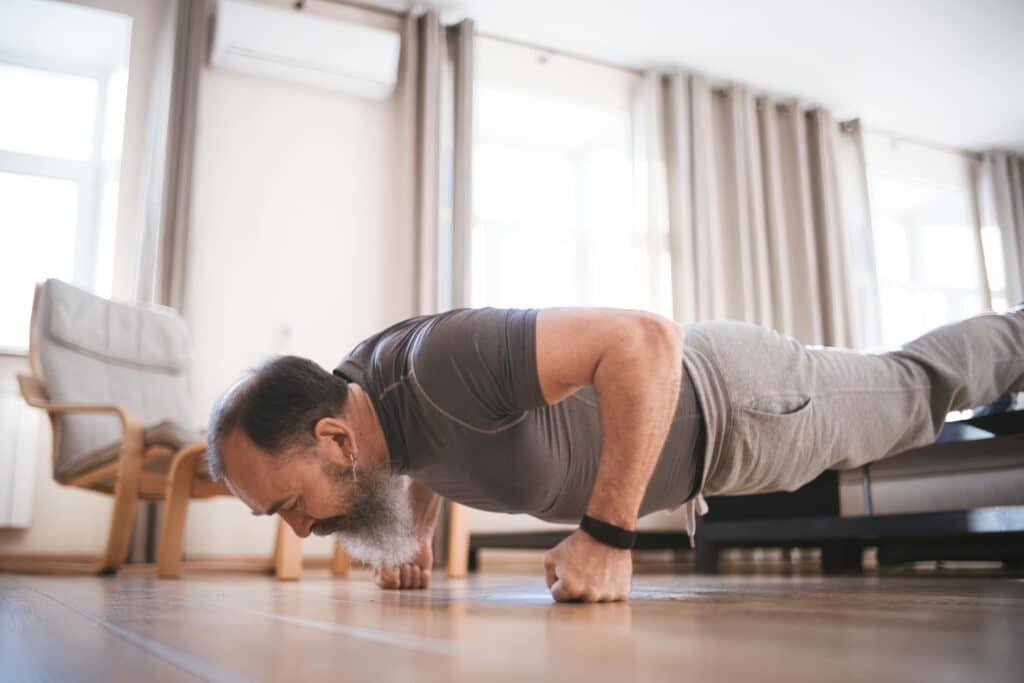 Man doing push-up at home - chest workout at home without equipment