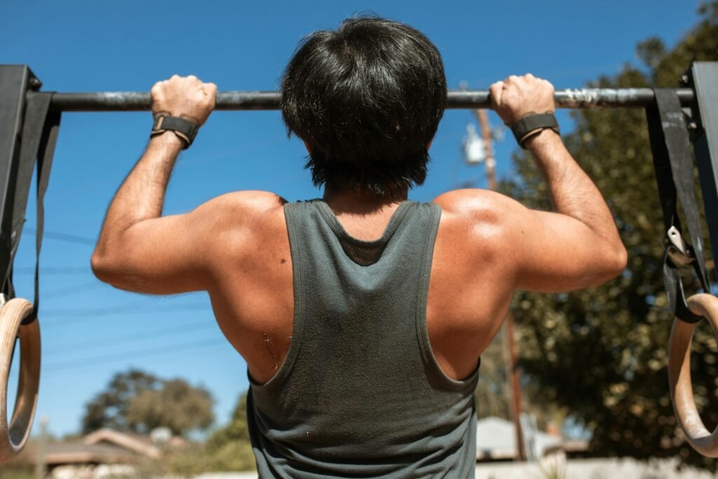 Man doing pull-ups on outdoor bar - 30-day calisthenics workout plan