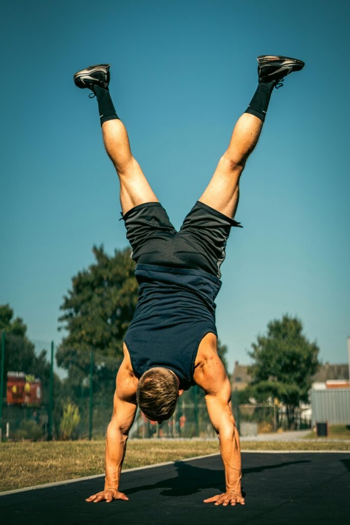 Man doing a handstand outdoors - calisthenics workout plan for beginners