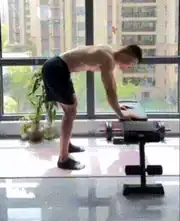 Man raises his heels in a bent-over calf raise for leg training bodyweight.