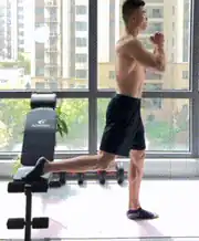 Man uses a bench for a Bulgarian split squat in bodyweight leg workouts.