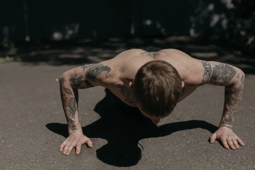 Man performing a controlled wide push-up targeting outer chest workout