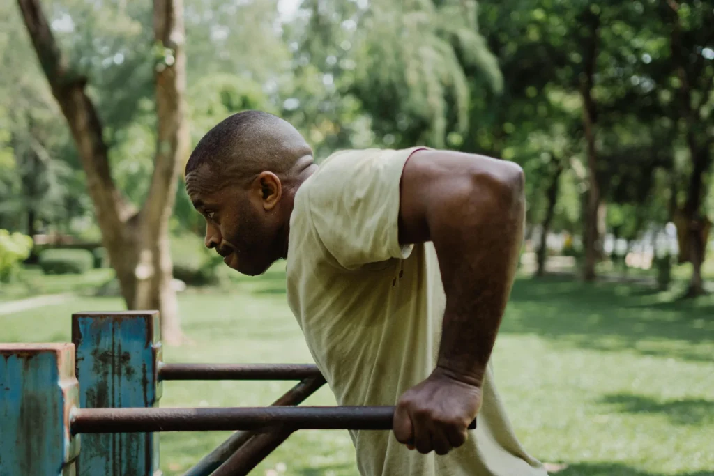 Man performing parallel-bar chest dips targeting lower chest muscles