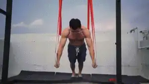Man doing ring chest squeeze push-up as inner pec workout.