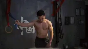 Man performing single-arm high-to-low resistance band chest fly for inside chest workout.