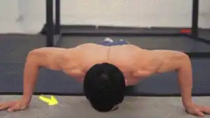 Man doing wide-grip internally angled push-up for work inner pecs.