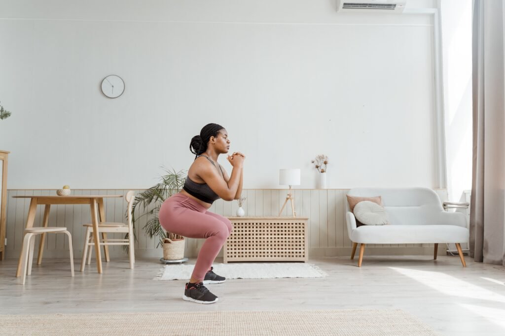 A woman performing a bodyweight squat.