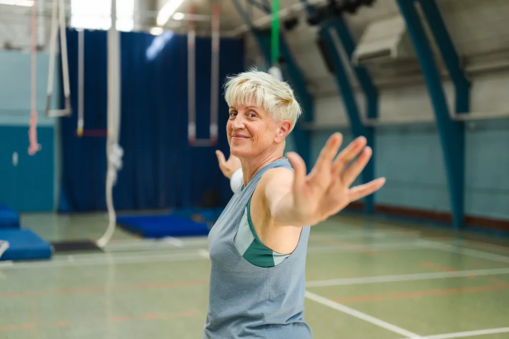 Woman doing Arm Circles movements as calisthenics warm up before exercises