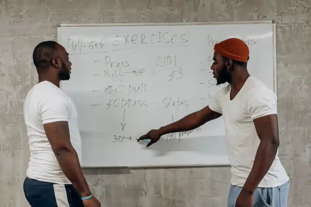 Two people discussing a 30-day calisthenics workout plan