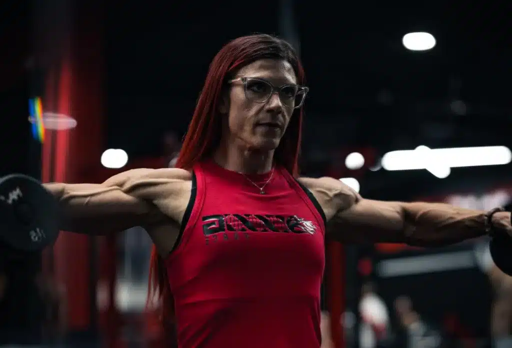 A strong woman doing standing dumbbell lateral raise